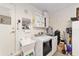 Functional laundry room with washer, dryer, sink, and storage cabinets at 8648 Sw 95Th Ln # A, Ocala, FL 34481