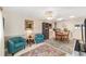 Living room adjacent to kitchen features tile floors, ceiling fan, and comfortable seating at 8648 Sw 95Th Ln # A, Ocala, FL 34481