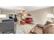 Cozy living room featuring hardwood floors, ceiling fan, and comfortable seating arrangement at 8648 Sw 95Th Ln # A, Ocala, FL 34481
