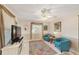 Comfortable living room features tile floors, ceiling fan, and large window with natural light at 8648 Sw 95Th Ln # A, Ocala, FL 34481