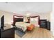 Comfortable main bedroom featuring a ceiling fan, wood-look floors, and modern furnishings at 8648 Sw 95Th Ln # A, Ocala, FL 34481