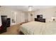 Inviting main bedroom with wood-look flooring, ceiling fan, and ensuite bathroom at 8648 Sw 95Th Ln # A, Ocala, FL 34481