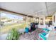Spacious screened patio with grill and seating, offering an outdoor living space at 8648 Sw 95Th Ln # A, Ocala, FL 34481