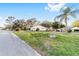 Expansive front yard with lush lawn, scattered trees, and a view of the charming single-story home at 8648 Sw 95Th Ln # A, Ocala, FL 34481