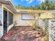 A cozy back patio with red tile, a screened room, and lattice work, perfect for outdoor relaxation at 9331 Sw 84Th Ter # F, Ocala, FL 34481