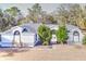 Single-story house with a gray roof and landscaping at 10043 Sw 202Nd Cir, Dunnellon, FL 34431