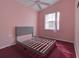 Bedroom with pink walls and a gray bed at 10043 Sw 202Nd Cir, Dunnellon, FL 34431