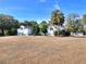 The front exterior of the house, showing a large yard and landscaping at 10043 Sw 202Nd Cir, Dunnellon, FL 34431