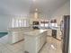 Kitchen with an island, white cabinets, and black appliances at 10043 Sw 202Nd Cir, Dunnellon, FL 34431