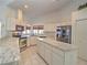 White kitchen with an island and black appliances at 10043 Sw 202Nd Cir, Dunnellon, FL 34431