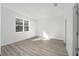 Well-lit bedroom with a large window offering natural light and wood-look flooring at 10322 Sw 99Th Ln, Ocala, FL 34481