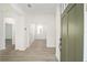 Bright entryway featuring wood-look floors, white walls, and a view into other rooms at 10322 Sw 99Th Ln, Ocala, FL 34481