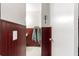 View of bathroom with dark wood wainscoting and a glimpse of the sink at 10425 Se 159Th Lane, Summerfield, FL 34491