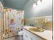 Bathroom with sunflower shower curtain and vintage vanity at 10425 Se 159Th Lane, Summerfield, FL 34491