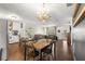 Open concept dining area with a rustic wooden table at 10425 Se 159Th Lane, Summerfield, FL 34491