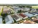 Aerial view of single Gathering homes in a neatly planned neighborhood with mature trees, lawns and a golf course at 1112 Carvello Dr, The Villages, FL 32162