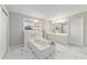 Large bathroom with soaking tub, double vanity, and marble floors at 1133 Se 24Th Ter, Ocala, FL 34471