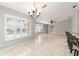 Bright dining room with large windows and chandelier at 1133 Se 24Th Ter, Ocala, FL 34471