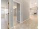 Bright hallway with light gray walls and tile flooring, leading to other rooms at 1133 Se 24Th Ter, Ocala, FL 34471