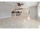 Sunlit living room with tile floors and views to the kitchen at 1133 Se 24Th Ter, Ocala, FL 34471