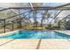 Enclosed pool with brick pavers and a covered patio area at 1133 Se 24Th Ter, Ocala, FL 34471