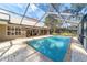 Enclosed pool with brick pavers and a covered patio area at 1133 Se 24Th Ter, Ocala, FL 34471