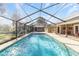 Enclosed pool with brick pavers and a covered patio area at 1133 Se 24Th Ter, Ocala, FL 34471