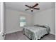 Cozy bedroom with a ceiling fan, one window, and a comfortable bed, creating a relaxing and inviting space at 13787 Sw 43Rd Cir, Ocala, FL 34473