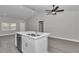 Kitchen island with stainless steel appliances and a ceiling fan at 13787 Sw 43Rd Cir, Ocala, FL 34473