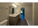 This bathroom features a double sink vanity with modern fixtures, and a walk-in shower with a tile surround at 14259 Se 33Rd Ter, Summerfield, FL 34491