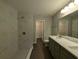 Bathroom with modern fixtures, including a dual shower and a double vanity at 14259 Se 33Rd Ter, Summerfield, FL 34491