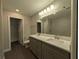 Bright bathroom featuring a double sink vanity, modern lighting, and a walk-in shower at 14259 Se 33Rd Ter, Summerfield, FL 34491