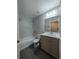 Modern bathroom with a combination shower and tub and stylish vanity at 14259 Se 33Rd Ter, Summerfield, FL 34491