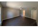 Bedroom featuring wood-look floors and connecting doors to a bathroom and closet at 14259 Se 33Rd Ter, Summerfield, FL 34491