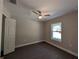 Cozy bedroom with wood-look floors, ceiling fan, window with natural light at 14259 Se 33Rd Ter, Summerfield, FL 34491