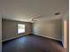 Spacious bedroom with wood-look flooring, a window and a ceiling fan at 14259 Se 33Rd Ter, Summerfield, FL 34491