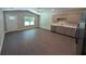 Open living room/kitchen combination with stainless steel appliances and wood-look flooring at 14259 Se 33Rd Ter, Summerfield, FL 34491
