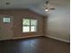 Bright living room featuring wood-look flooring, a window view and a ceiling fan at 14259 Se 33Rd Ter, Summerfield, FL 34491