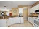 Modern kitchen with granite countertops and white cabinets at 14315 Se 85Th Ave, Summerfield, FL 34491