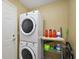 Well-lit laundry room, features a stackable washer and dryer at 14315 Se 85Th Ave, Summerfield, FL 34491