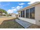 Covered patio with screened enclosure and tile flooring at 14315 Se 85Th Ave, Summerfield, FL 34491