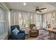 Relaxing sunroom with comfy seating and a ceiling fan at 14315 Se 85Th Ave, Summerfield, FL 34491