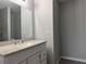 Bathroom with white vanity, granite countertop and a large mirror at 15801 Sw 37Th Cir, Ocala, FL 34473