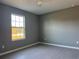 Bright bedroom with grey walls, ceiling fan, and large window at 15801 Sw 37Th Cir, Ocala, FL 34473