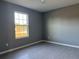 Simple bedroom with large window and tile floors at 15801 Sw 37Th Cir, Ocala, FL 34473