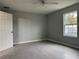 Spacious bedroom featuring grey walls, tile floors, and a window at 15801 Sw 37Th Cir, Ocala, FL 34473