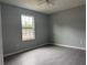 Bright bedroom with grey walls, tile floors, and a large window at 15801 Sw 37Th Cir, Ocala, FL 34473