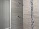 Modern shower with grey tile and a mosaic accent strip at 15801 Sw 37Th Cir, Ocala, FL 34473