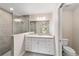 Modern bathroom with white vanity, granite countertop and large shower at 17715 Sw 113Th Pl, Dunnellon, FL 34432