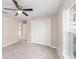 Bedroom with ceiling fan, carpet, and double doors at 17715 Sw 113Th Pl, Dunnellon, FL 34432